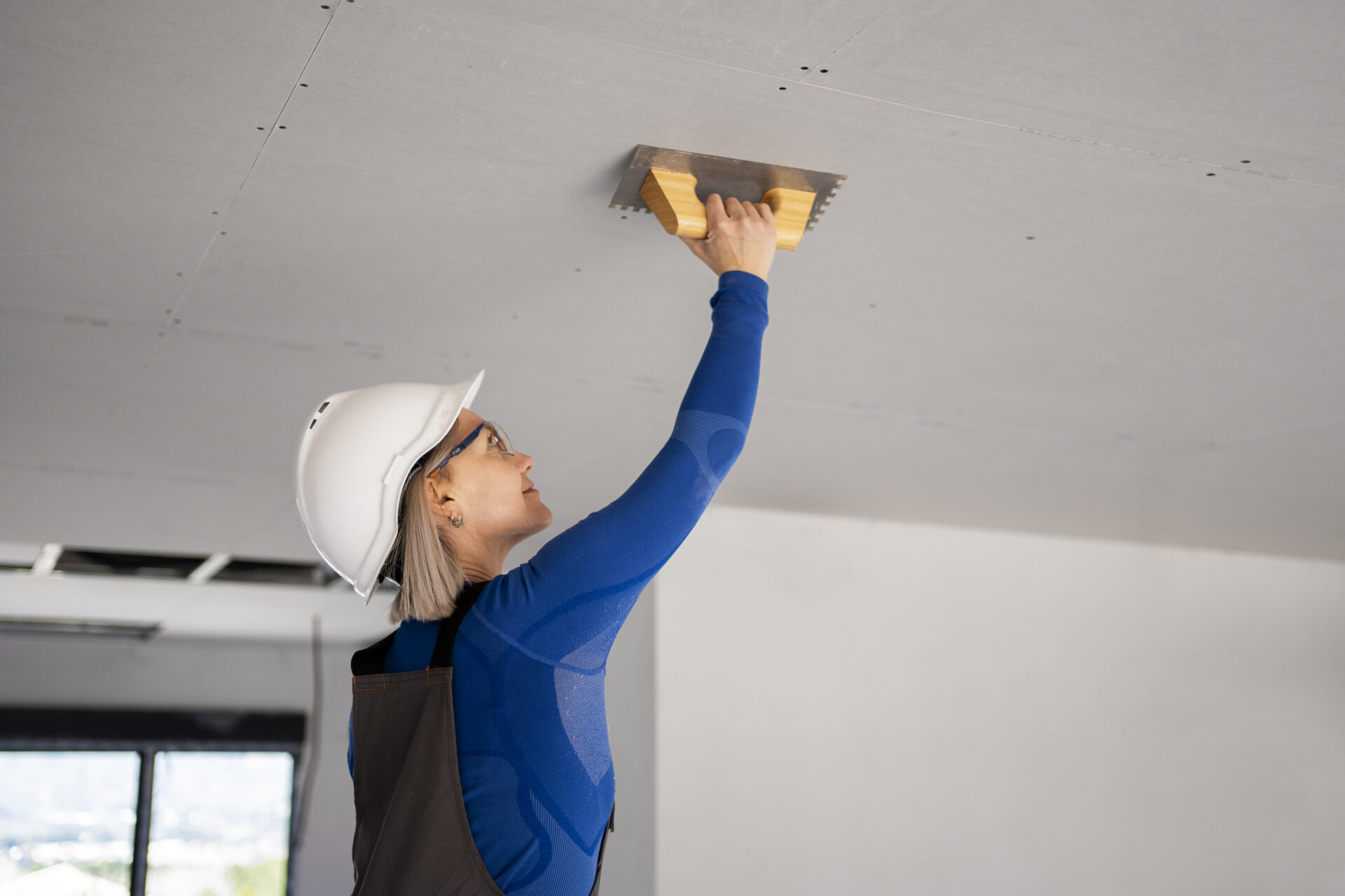 medium-shot-smiley-woman-fixing-roof